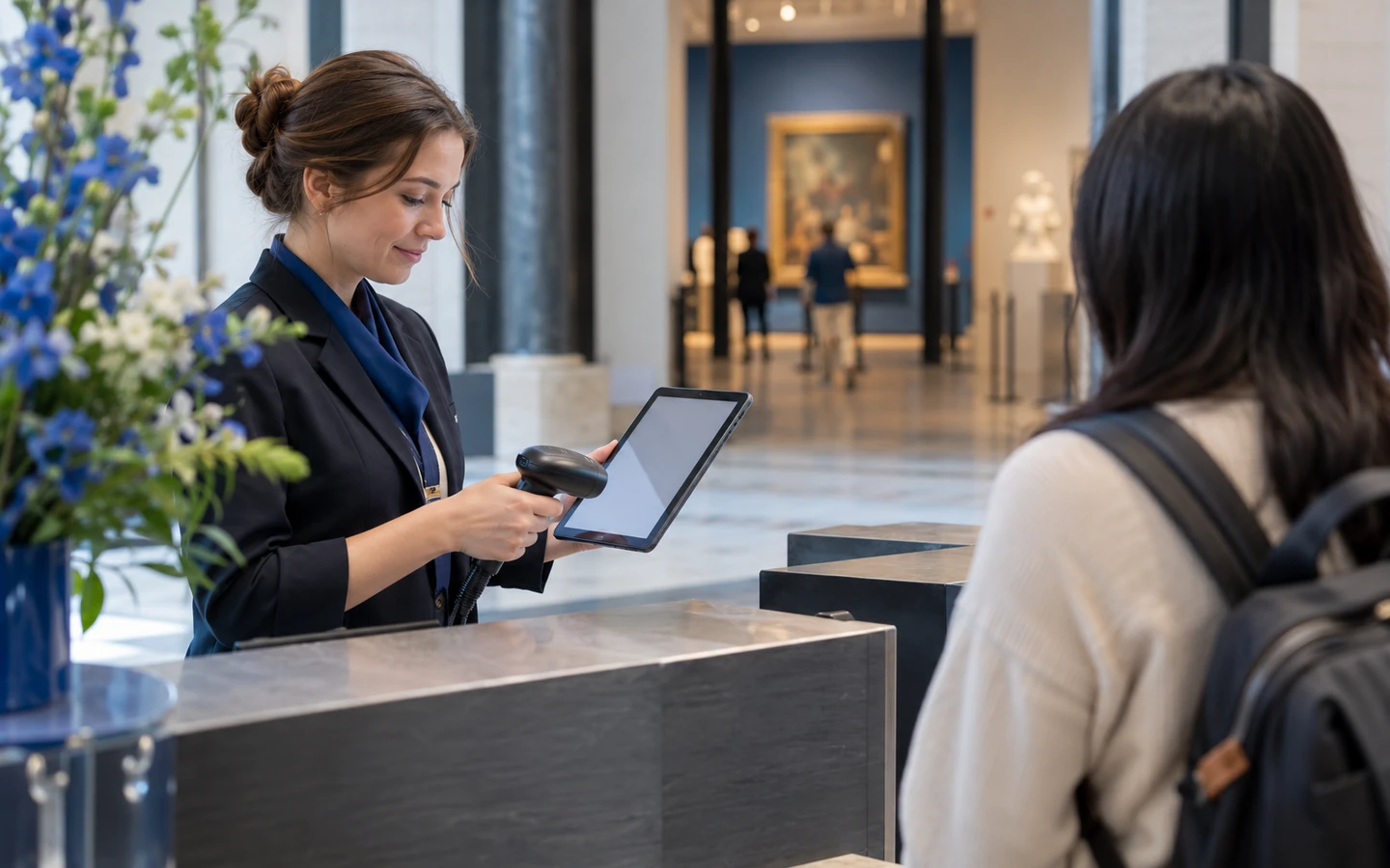 An attraction operator testing a guest ticket and time slot at a counter before making inventory available through a partner.